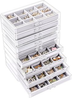 the drawers are filled with jewelry and rings