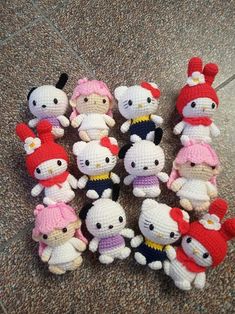 a group of hello kitty stuffed animals sitting on the ground