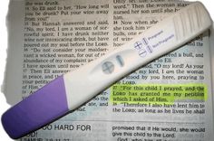 a purple and white toothbrush sitting on top of an open bible paper with the word god hard for