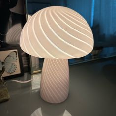 a white lamp sitting on top of a table