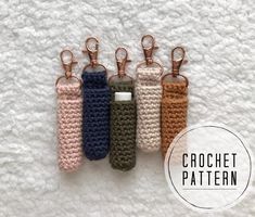 four crochet keychains are lined up on a white surface with the words crochet pattern below them