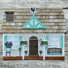 a paper house with potted plants on the front