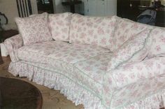 a white couch with pink flowers on it