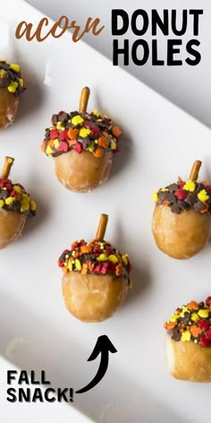 mini acorn holes are decorated with candy and sprinkles