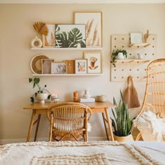 a bed room with a neatly made bed next to a wooden table and two wicker chairs