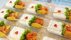 there are many small trays with food in them that is on top of rice