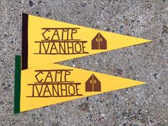 two yellow signs on the side of a road that say game vanee and home