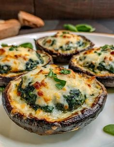 baked stuffed mushrooms with spinach and cheese on a white plate, ready to be eaten