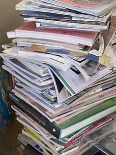 a stack of magazines sitting on top of a table