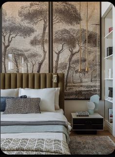 a bedroom with a large painting on the wall above the bed and pillows below it