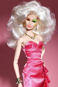 a barbie doll wearing a pink dress and green eyes