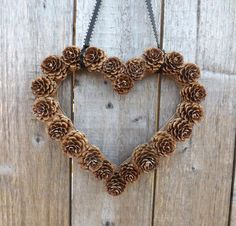 a heart shaped wreath made out of pine cones