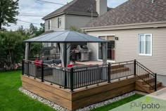 an outdoor patio with a grill and gazebo