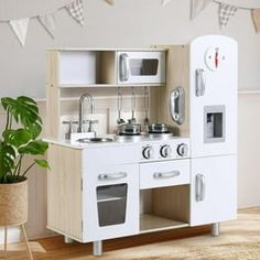 a play kitchen with white appliances and wooden floors