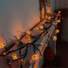 halloween decoration with pumpkins and lights on the mantle