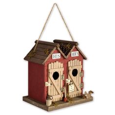 a red birdhouse with two doors and a sign on the side that says his