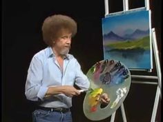 the man is painting on an easel with his hands