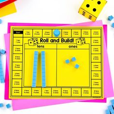 the roll and build game is on top of colored paper