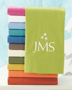 a stack of folded sheets with the initials j m s and stars in white on them