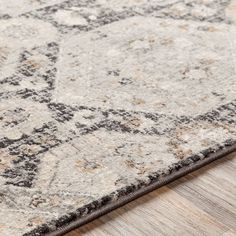 an area rug with grey and white colors