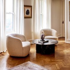 a living room with two chairs and a coffee table