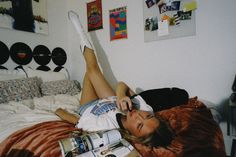 a woman laying on top of a bed in a bedroom