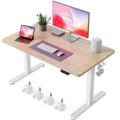 a computer desk with a laptop, keyboard and mouse next to it on top of a wooden table