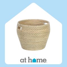 a woven basket with the words at home on it and an image of a house in the background