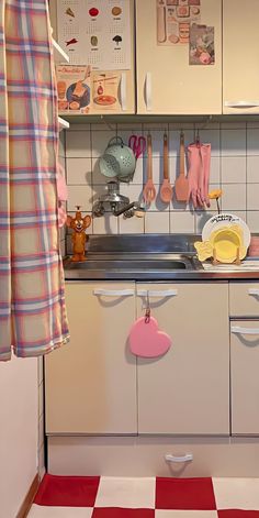 the kitchen is clean and ready to be used for cooking or baking, with utensils hanging on the wall