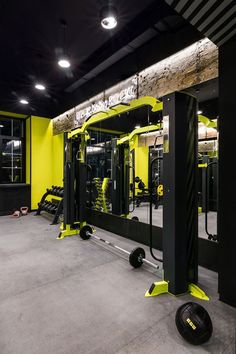 an empty gym with yellow and black equipment