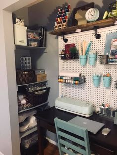 a craft room with pegboard and shelves