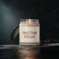 a candle that is sitting on a table with the words family drama repellant