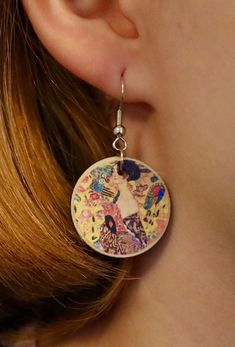 "Lady With A Fan - Gustav Klimt Show your love for the fine arts with our unique handmade earrings. You can wear these enchanting accessories at any given time and occasion to show others you're just as beautiful the painting. ✷ HANDMADE ✷  Handmade with love and care with high-quality wood and metal. Handcrafted in Finland with locally bought materials. ✷ Weatherproof ✷  The earrings have been coated with a weatherproof coating spray. No need to worry about rain!  ✷ Allergy-friendly ✷  All of our earrings are made with nickel tested / nickel free materials to insure that everyone's ears are safe wearing our earrings.  ✷ A Great Gift for Art Lovers ✷  You can also give our earrings to friends, family members, or art lovers on occasions such as birthday, mother's day, Christmas, anniversary Nickel-free Artsy Jewelry As Gift, Nickel-free Artsy Jewelry Gift, Artisan Earrings With Artistic Design As A Gift, Artisan Earrings With Artistic Design For Gift, Whimsical Hand Painted Silver Earrings, Whimsical Earrings For Mother's Day Gift, Artsy Pierced Jewelry As Gift, Artsy Pierced Jewelry For Gifts, Artsy Pierced Jewelry As A Gift