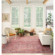 a living room filled with furniture and large windows