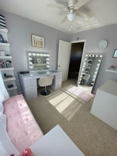 a bedroom with a vanity, desk and mirror