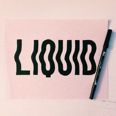 a piece of paper with the word liquid written on it and a marker next to it