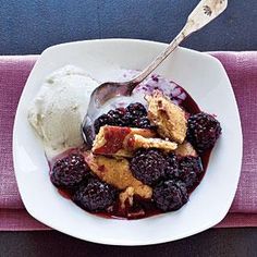 a white plate topped with berries and ice cream