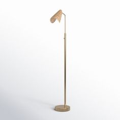 a gold floor lamp with a wooden base