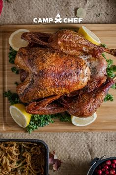 a roasted turkey on a platter with lemons and parsley