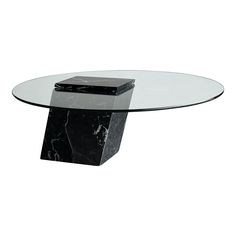 a black and white marble table with a glass top on it's base, in front of a white background