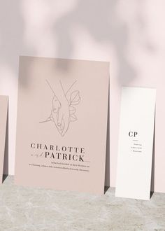 three folded cards sitting on top of a table next to each other with the words charlotte patrick printed on them