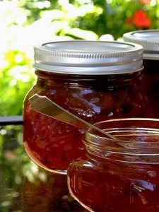 three jars filled with jam sitting on top of a table