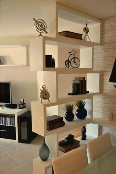 a living room filled with lots of white shelves