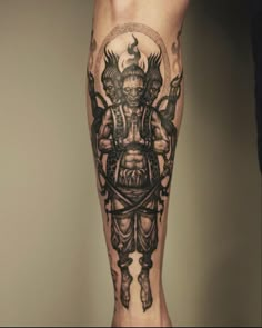 a man's leg with a tattoo on it and an image of a demon