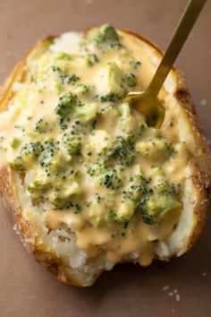 a piece of bread with broccoli and cheese on it