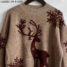 an ugly sweater with reindeers on it is hanging on a hanger in front of a white wall