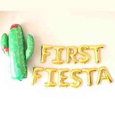 the first fiesta balloon is next to a cactus shaped balloon that says, first fiesta