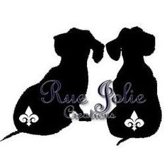 two dogs sitting next to each other with the words ruelle noir on their backs