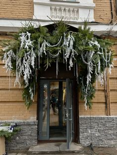 the front entrance to a building decorated for christmas