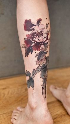 a woman's leg with flowers on it